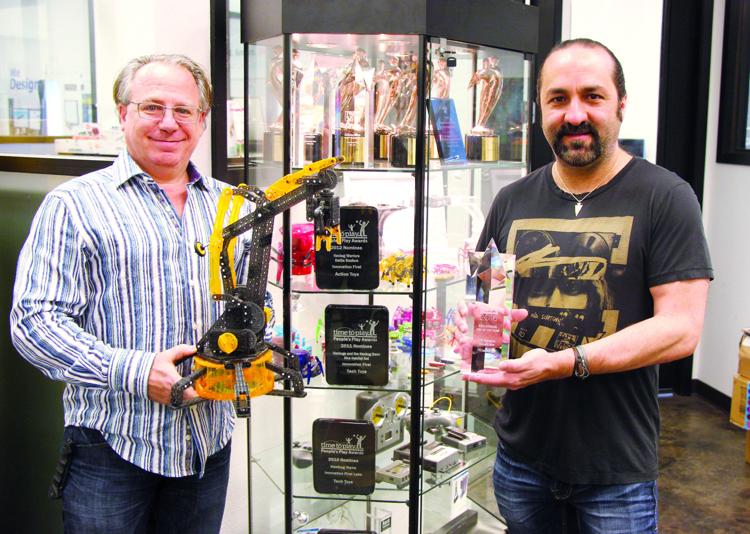Innovation First's Bob Mimlitch, left, and Tony Norman show off the company's Vex Robotic Arm by HEXBYG which received the award for Educational Toy of the Year at the Toy Industry Association's 16th Annual Toy of the Year Awards.